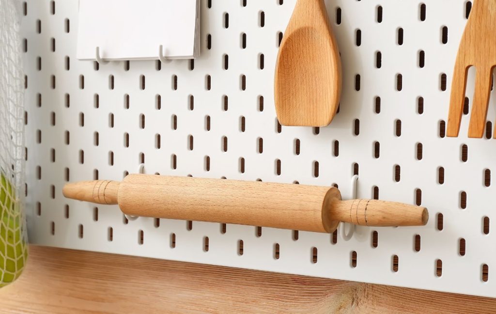 A pegboard for the vertical storage in a small kitchen