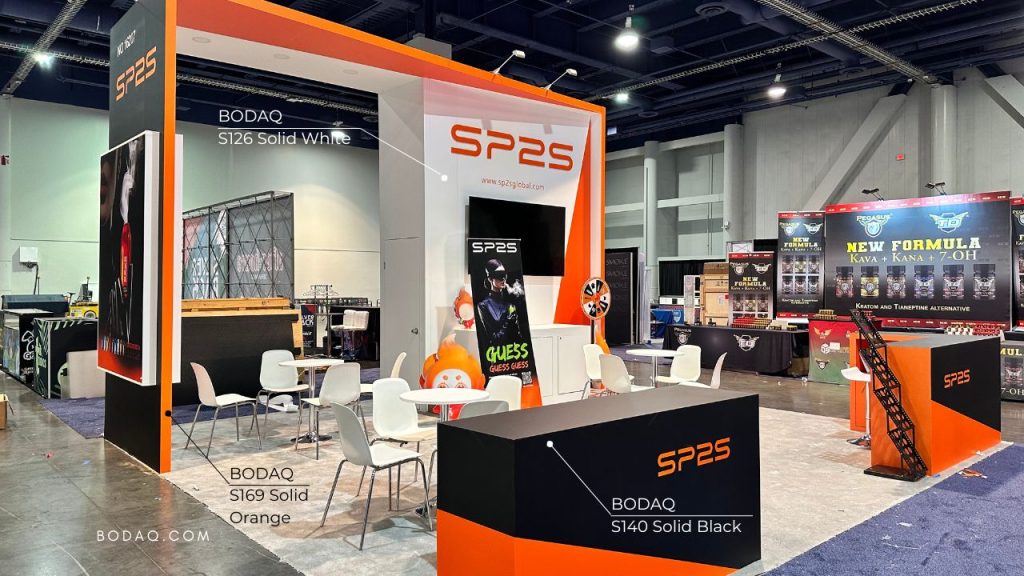 Booth design with Bodaq S140 Solid Black, S169 Solid Orange, and S126 Solid White