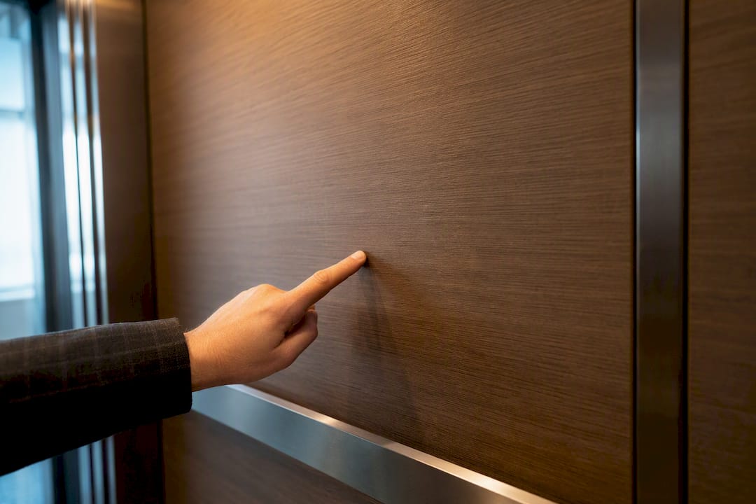 Wrapped elevator panel beside handrail