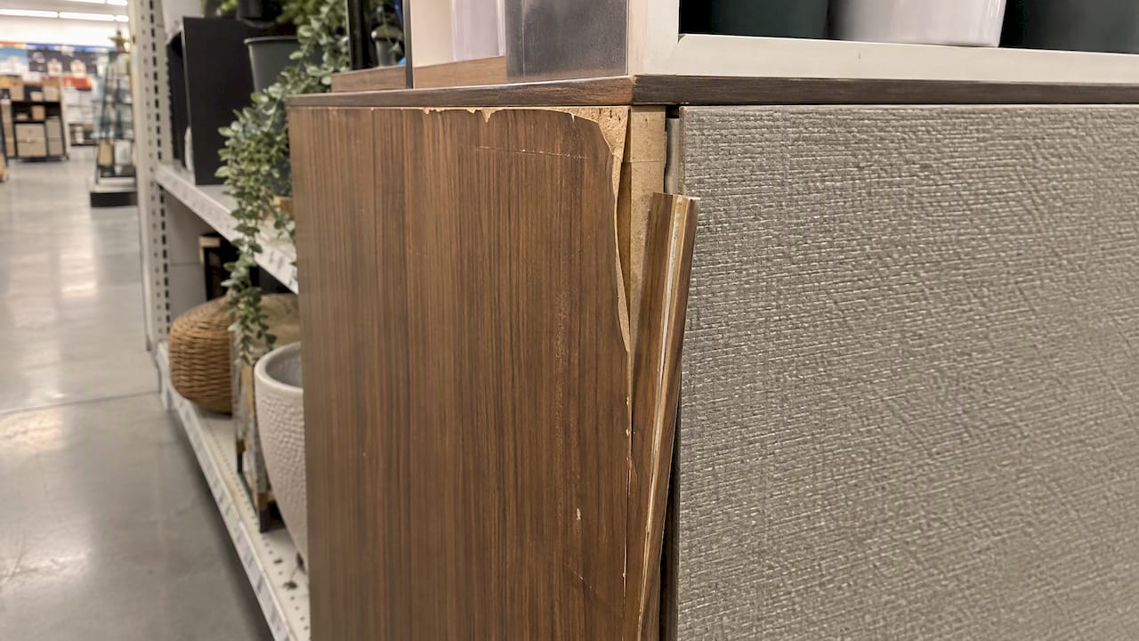 Retail fixture with lifted veneer and loose trim